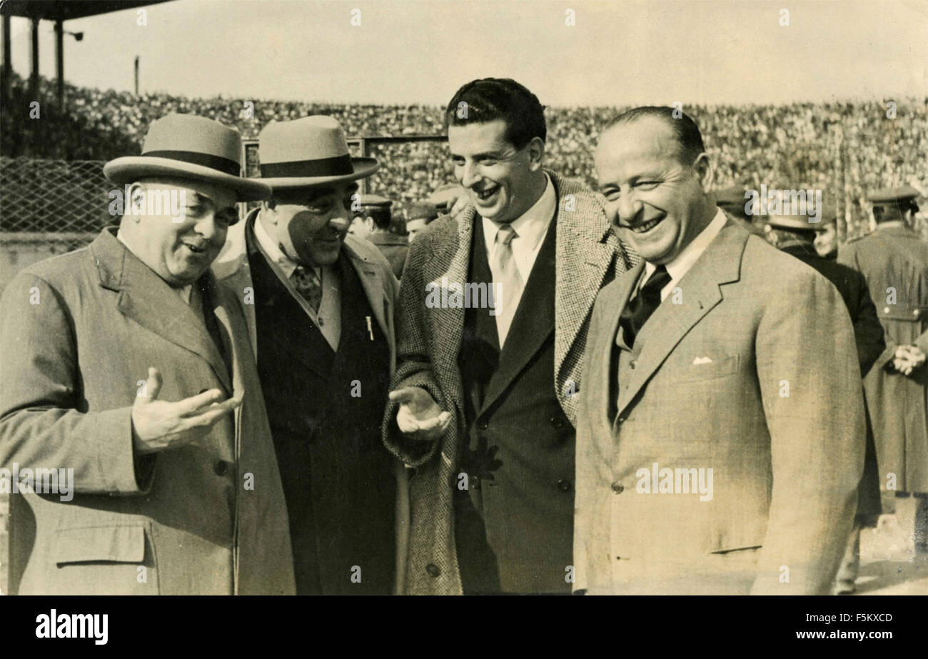 Four men discuss sports in a stadium, Italy Stock Photo