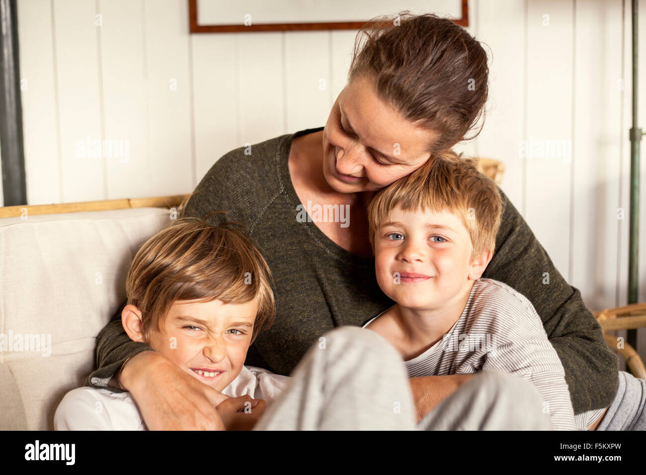Sweden, Uppland, Runmaro, Barrskar, Portrait of mother with two sons (4-5, 6-7) Stock Photo