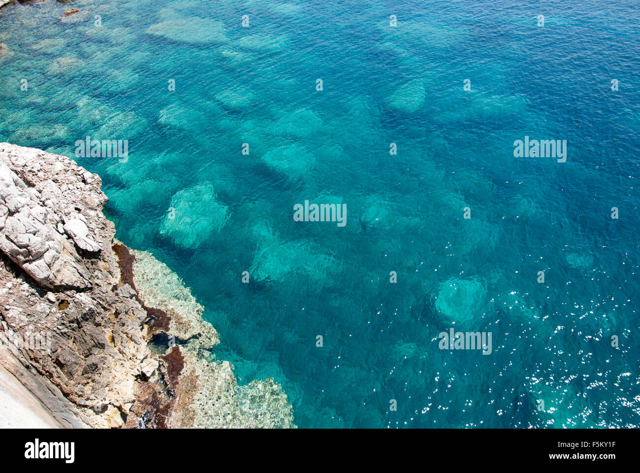 Sardinian blue green crystal sea seen from the top with rocks Stock Photo