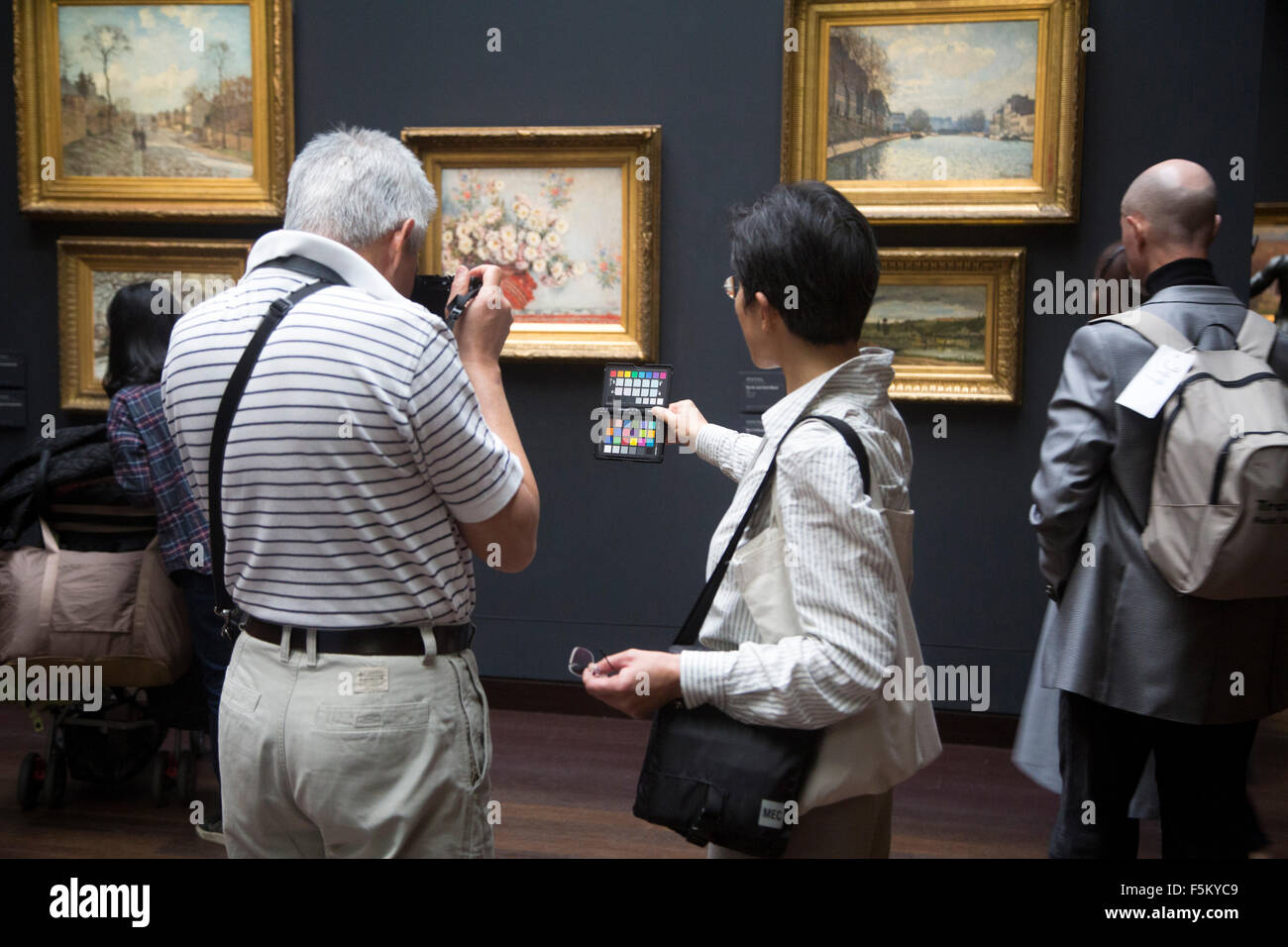 photographer in musee d'orsay, paris france checks colour temperature with chart Stock Photo