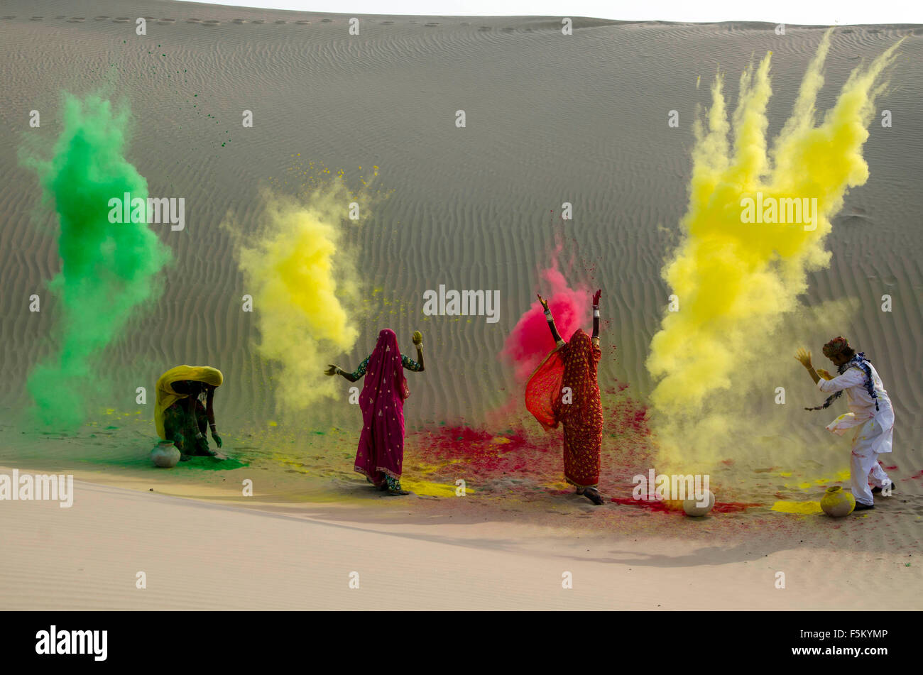 Men and women throwing dry colour in holi festival, jaisalmer, rajasthan, india, asia, no mr Stock Photo