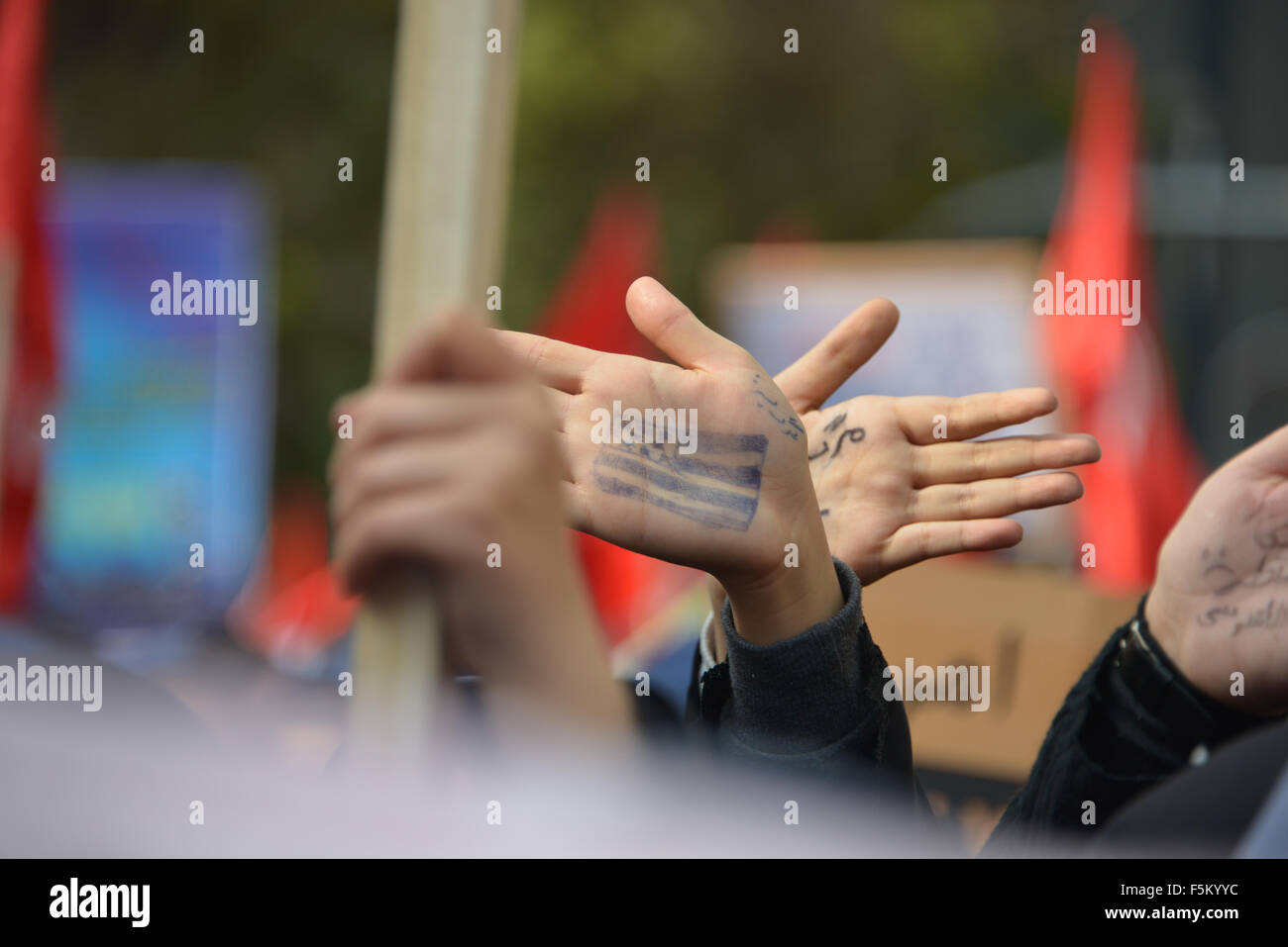 Tehran, Iran. 4th November, 2015.Young Iranian women  demonstrators in Tehran show their hands Wednesday, marked with slogans against the U.S. ,Thousands of Iranians burned the American flag and chanted slogans Wednesday as they marked the anniversary of the seizure of the U.S. Embassy in Tehran by students 36 years ago Stock Photo