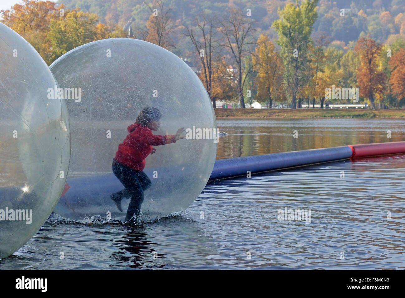 boy in water ball, River Vltava, Prague, Czech Republic Stock Photo