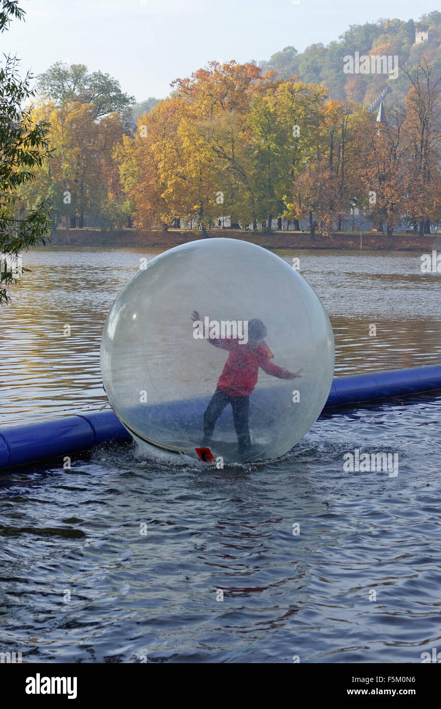 boy in water ball, River Vltava, Prague, Czech Republic Stock Photo