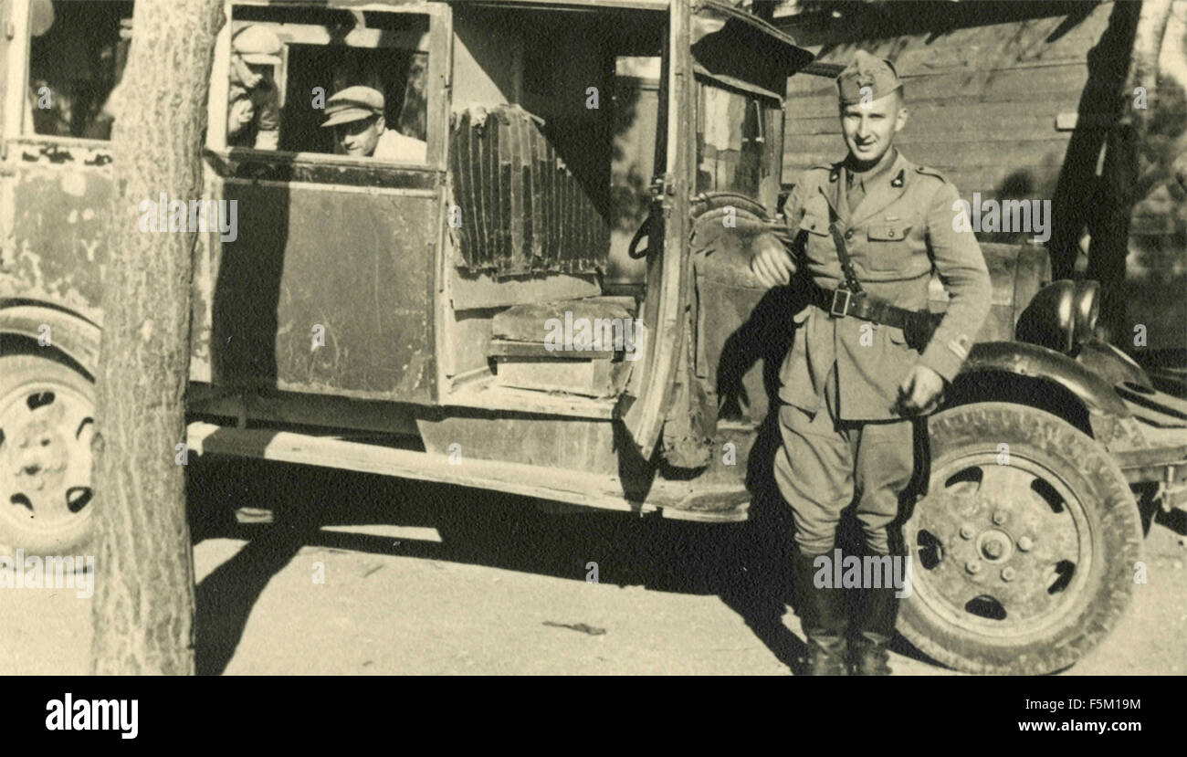 An Italian soldier next to a truck Stock Photo
