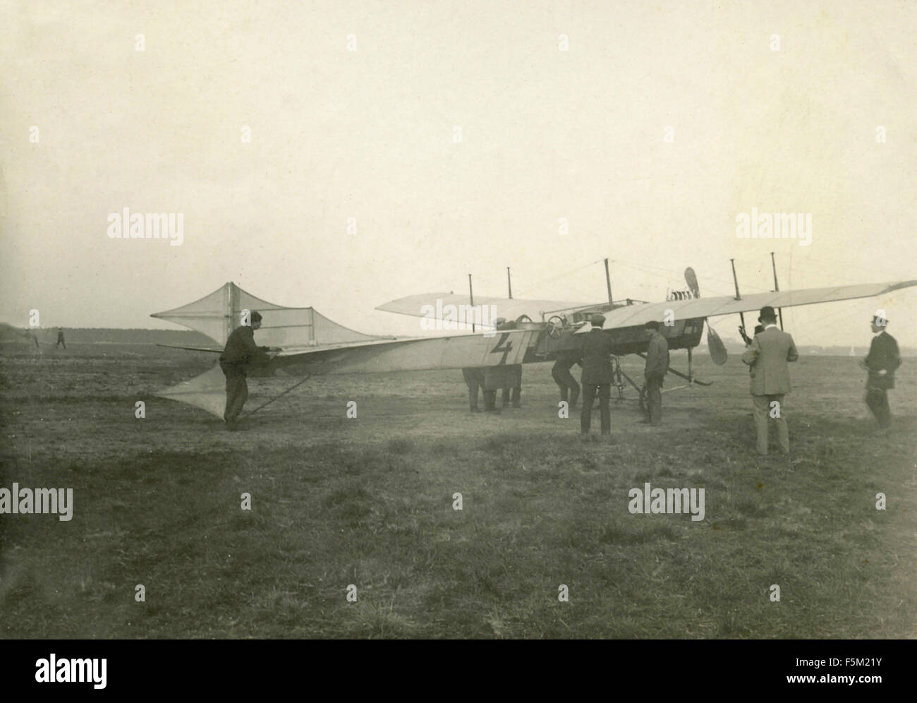 Group of people next to a light monoplane, Italy Stock Photo
