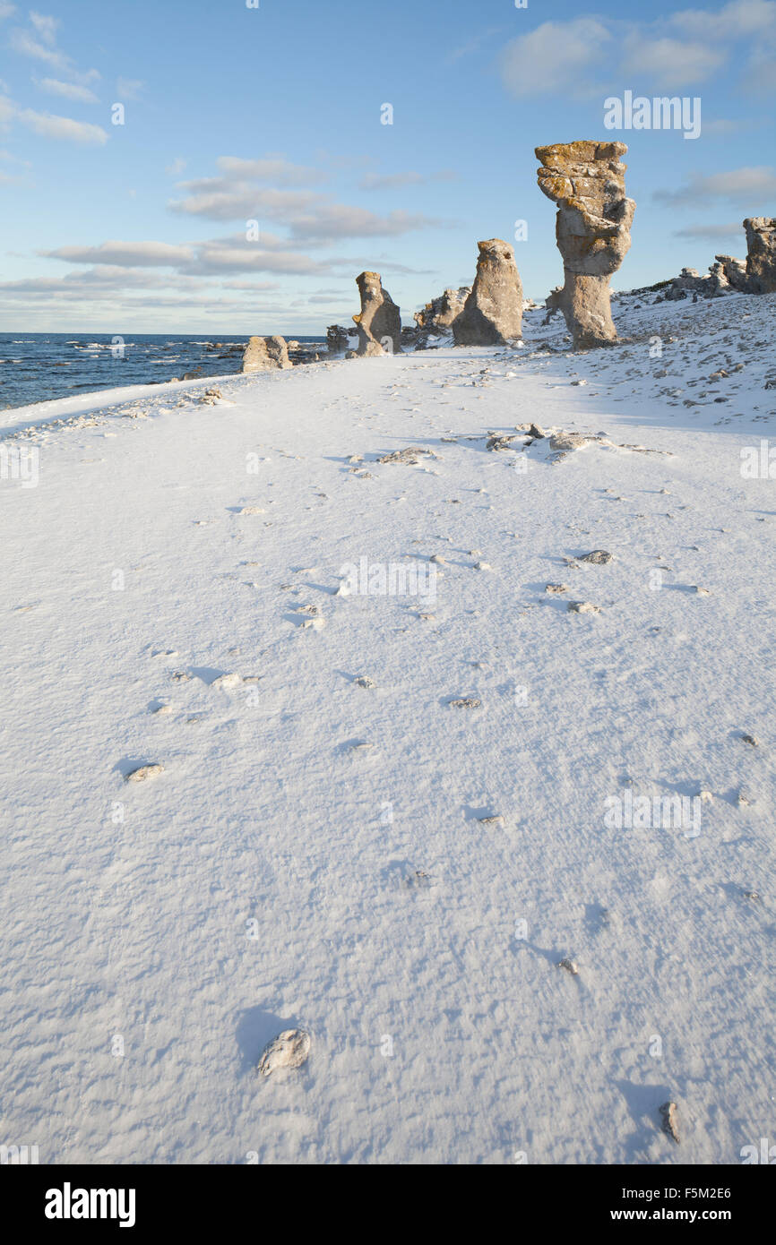 Sweden, Gotland, Faro, Rock formations on beach in winter Stock Photo