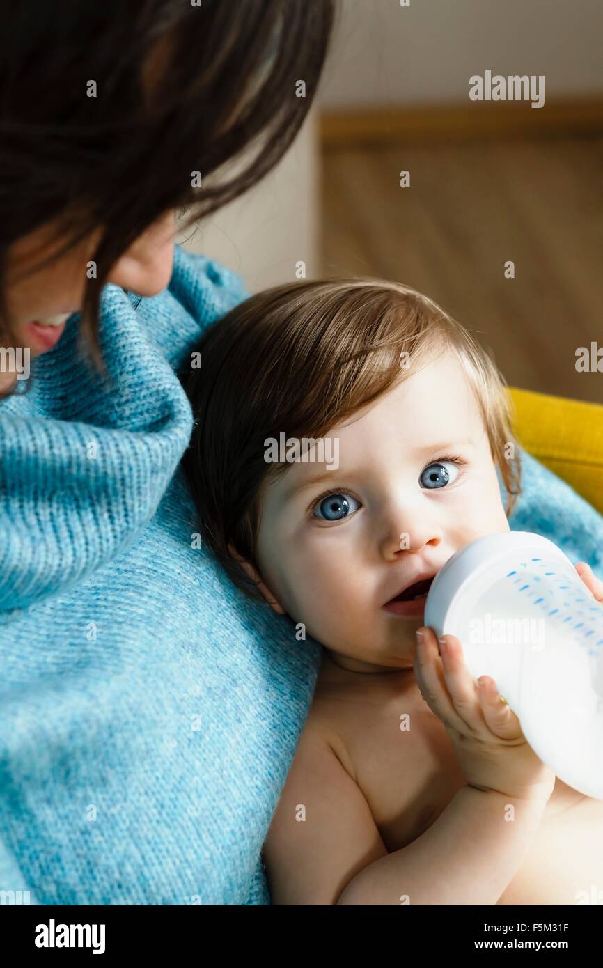 Mother and baby son drinking from bottle Stock Photo
