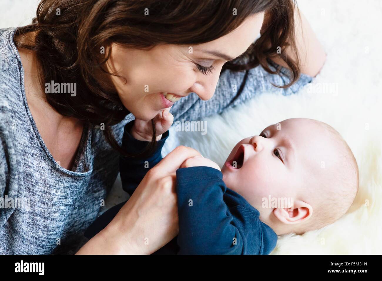 Mother smiling at her baby boy Stock Photo
