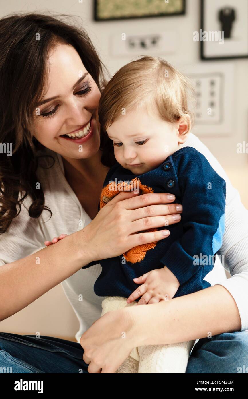 Mother holding standing baby son Stock Photo