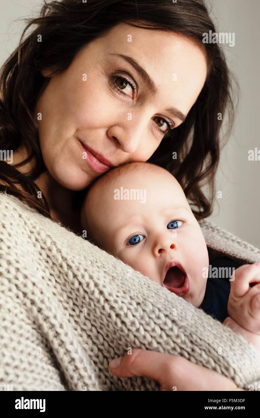 Mother and yawning baby son Stock Photo