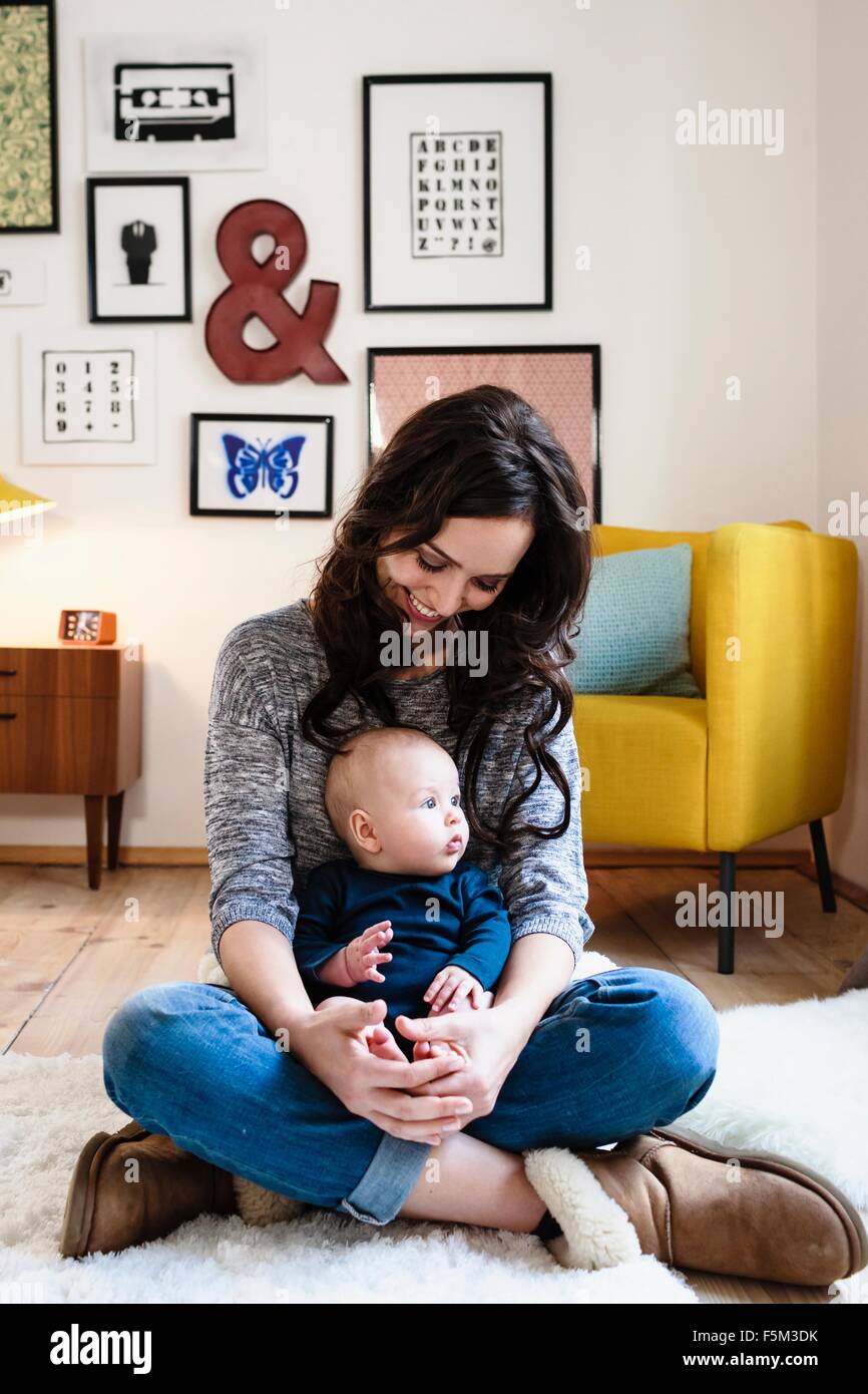 Mother and baby son sitting in living room Stock Photo