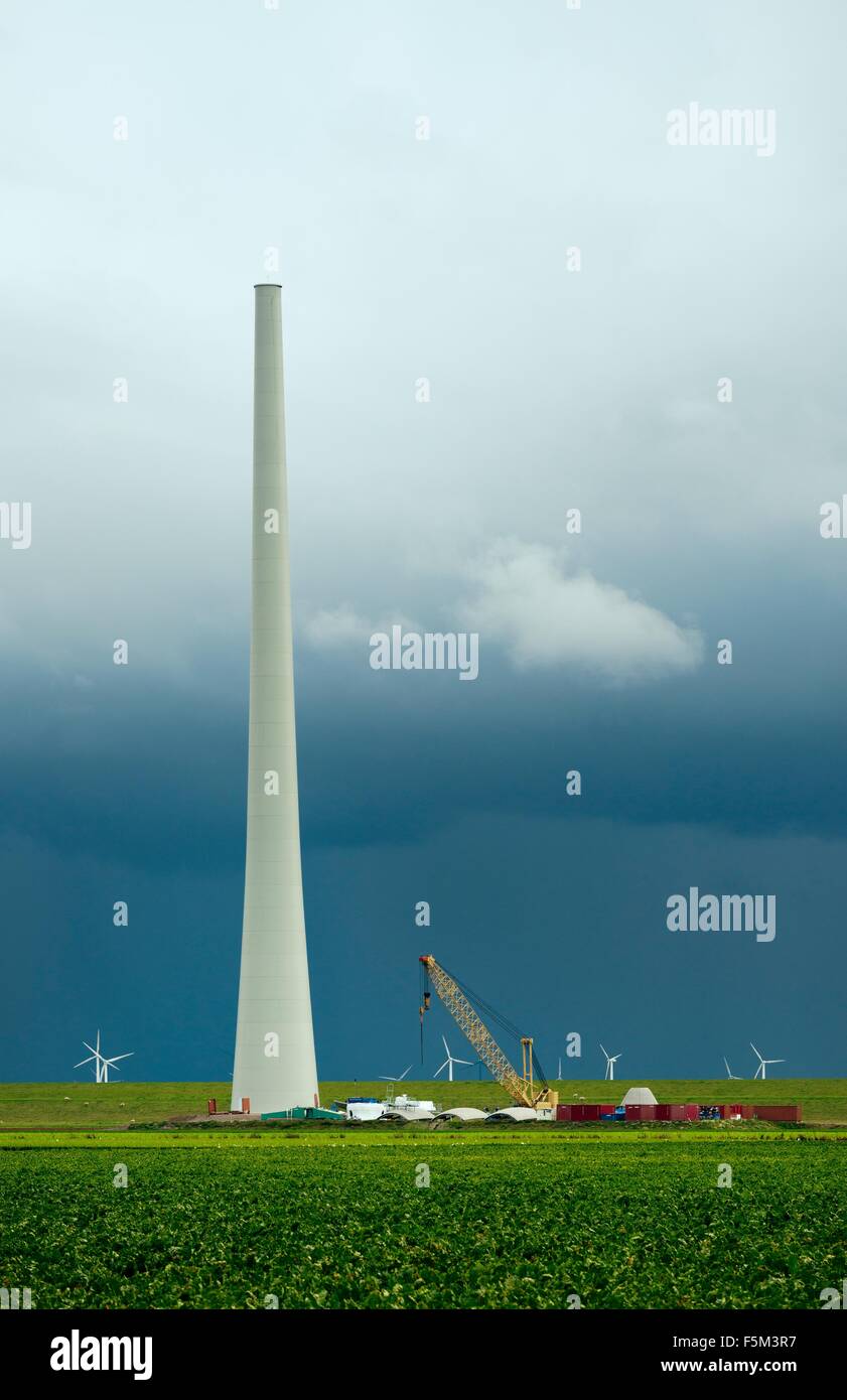 Thunderstorm approaching a wind turbine under construction, Netherlands Stock Photo