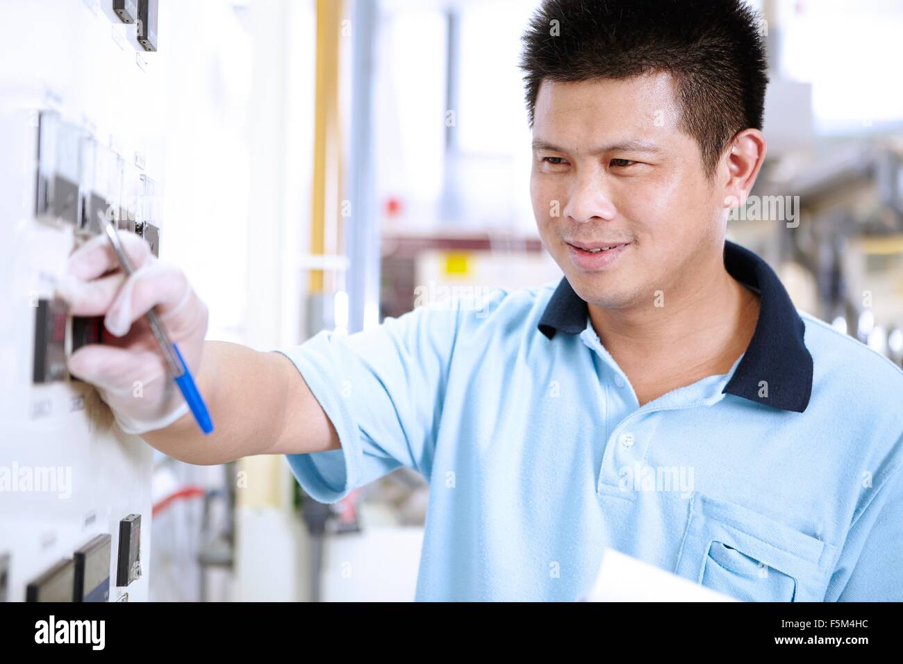 Man at control panel in flexible electronics plant Stock Photo - Alamy