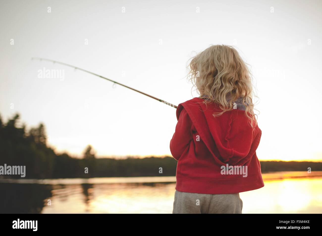 Girl fishing, Kings Lake, Ontario, Canada Stock Photo