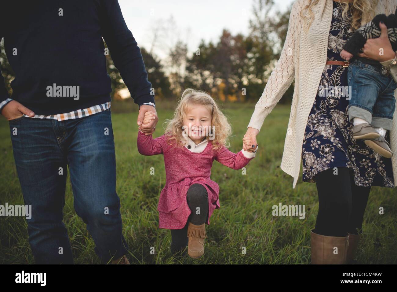 Cropped shot of mid adult couple strolling with daughter and baby boy Stock Photo