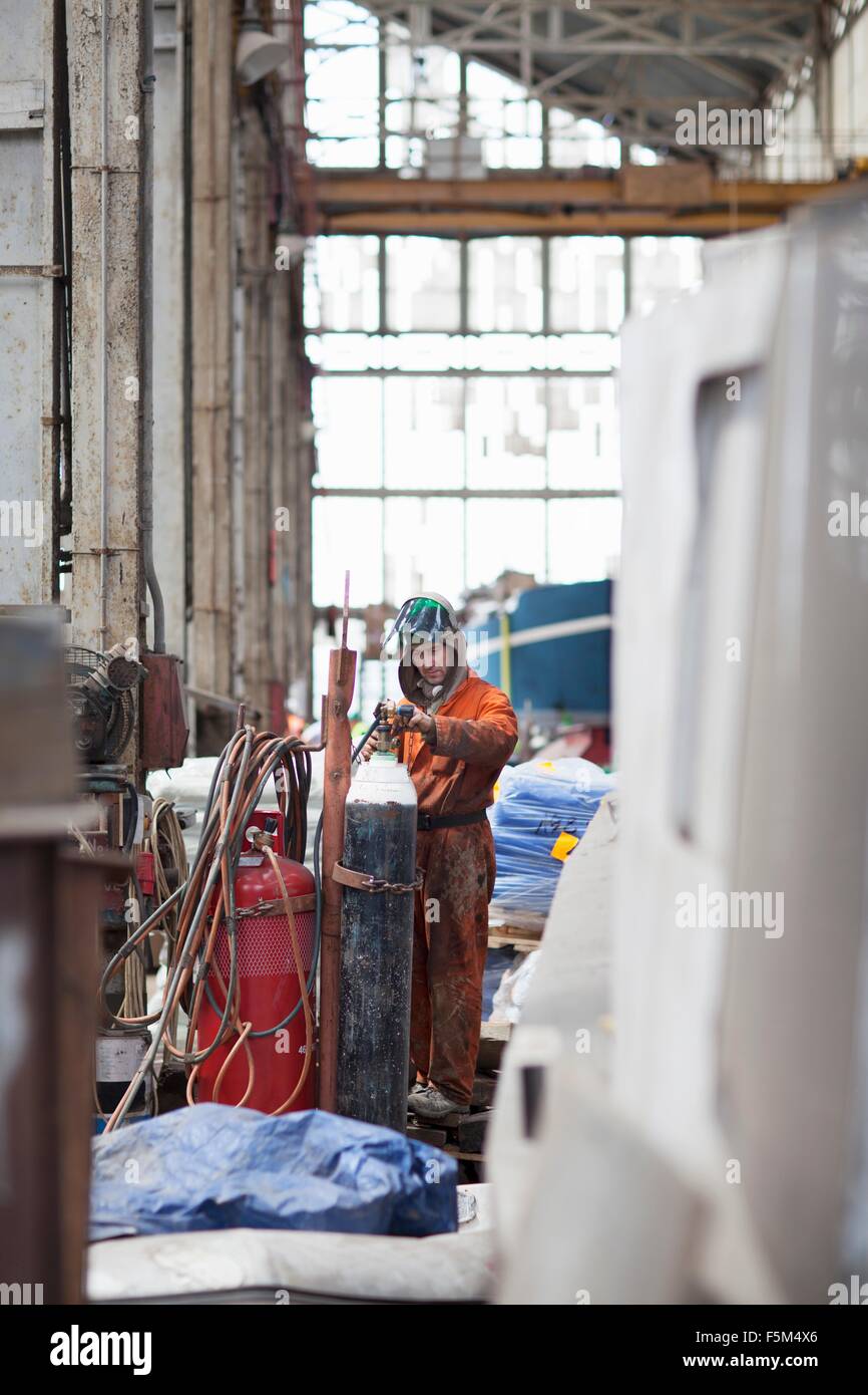 Welder checking gas cylinder in shipyard Stock Photo Alamy