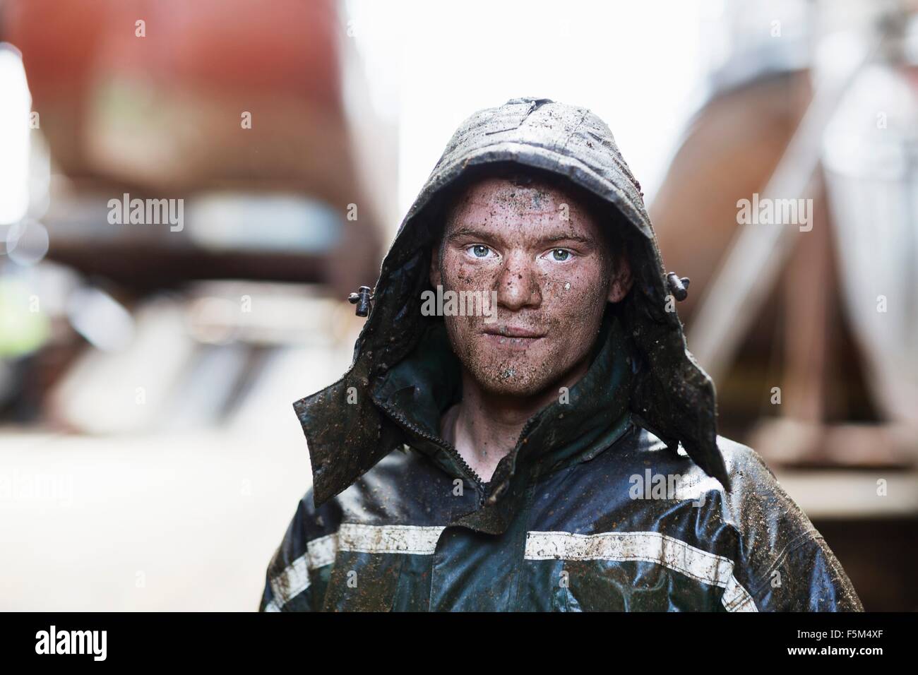 Portrait of young male boat builder in shipyard workshop Stock Photo