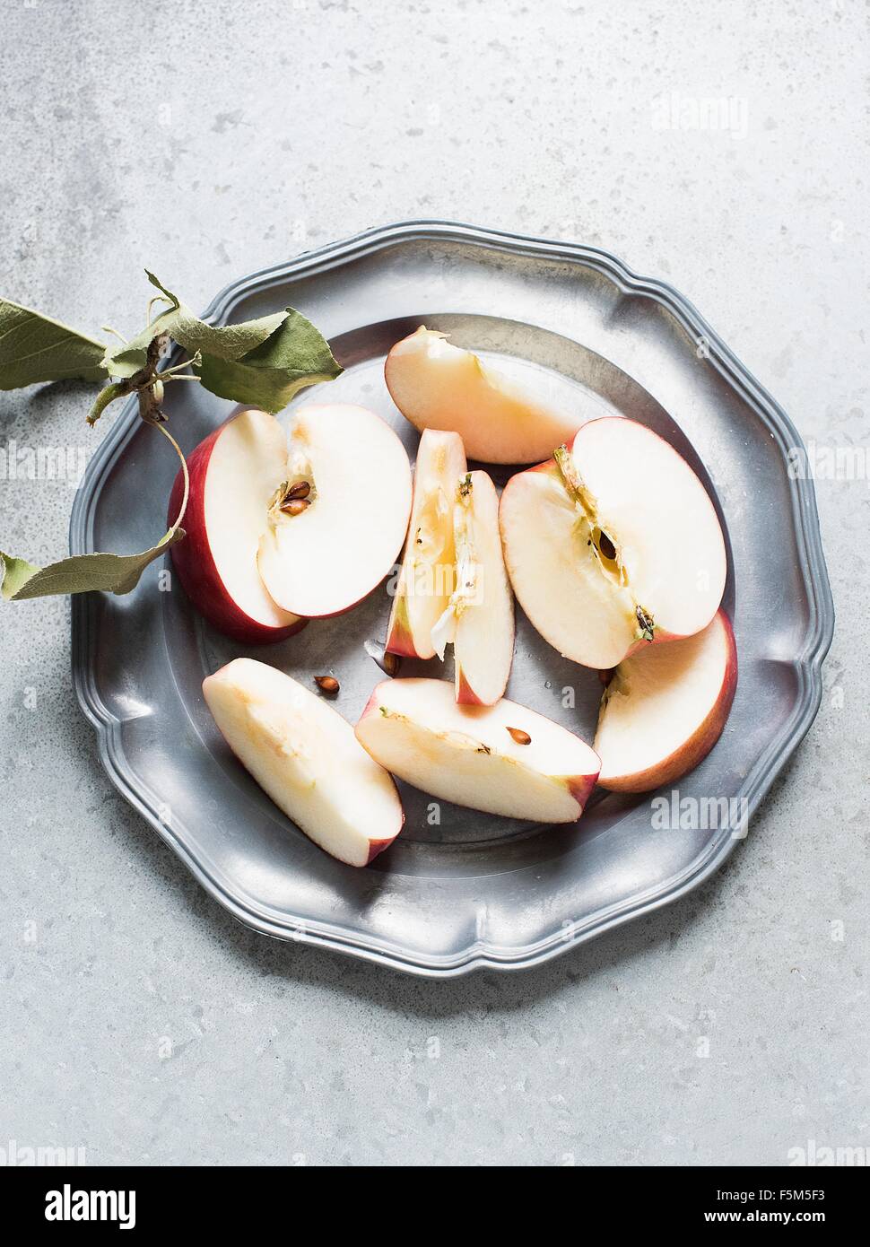Sliced apple on plate, overhead view Stock Photo Alamy