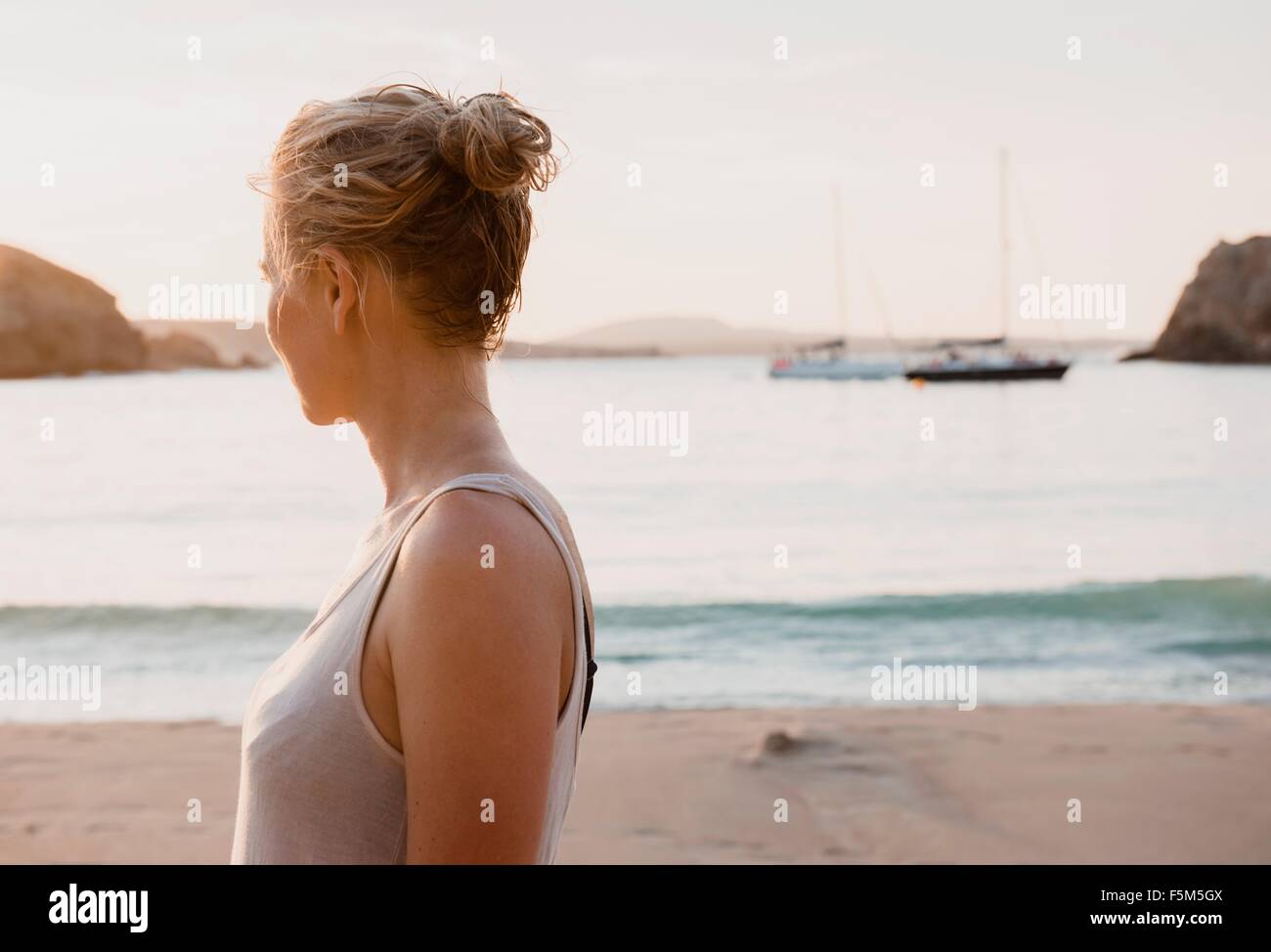 Mid adult woman looking out from beach, Menorca, Balearic islands, Spain Stock Photo