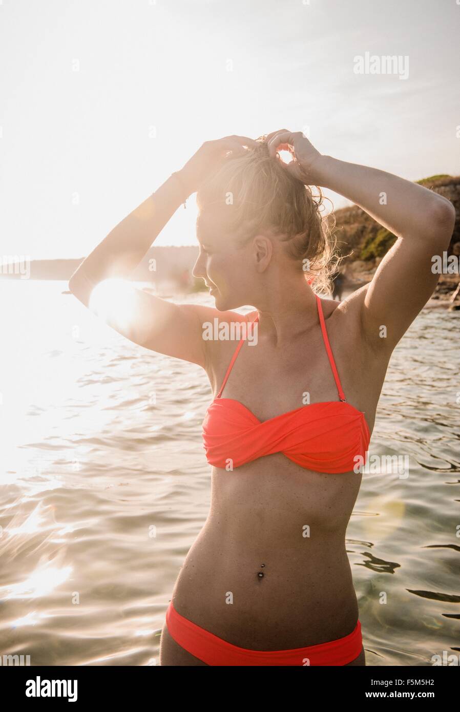 Sultry woman in sea wearing bikini, Menorca, Balearic islands, Spain Stock Photo