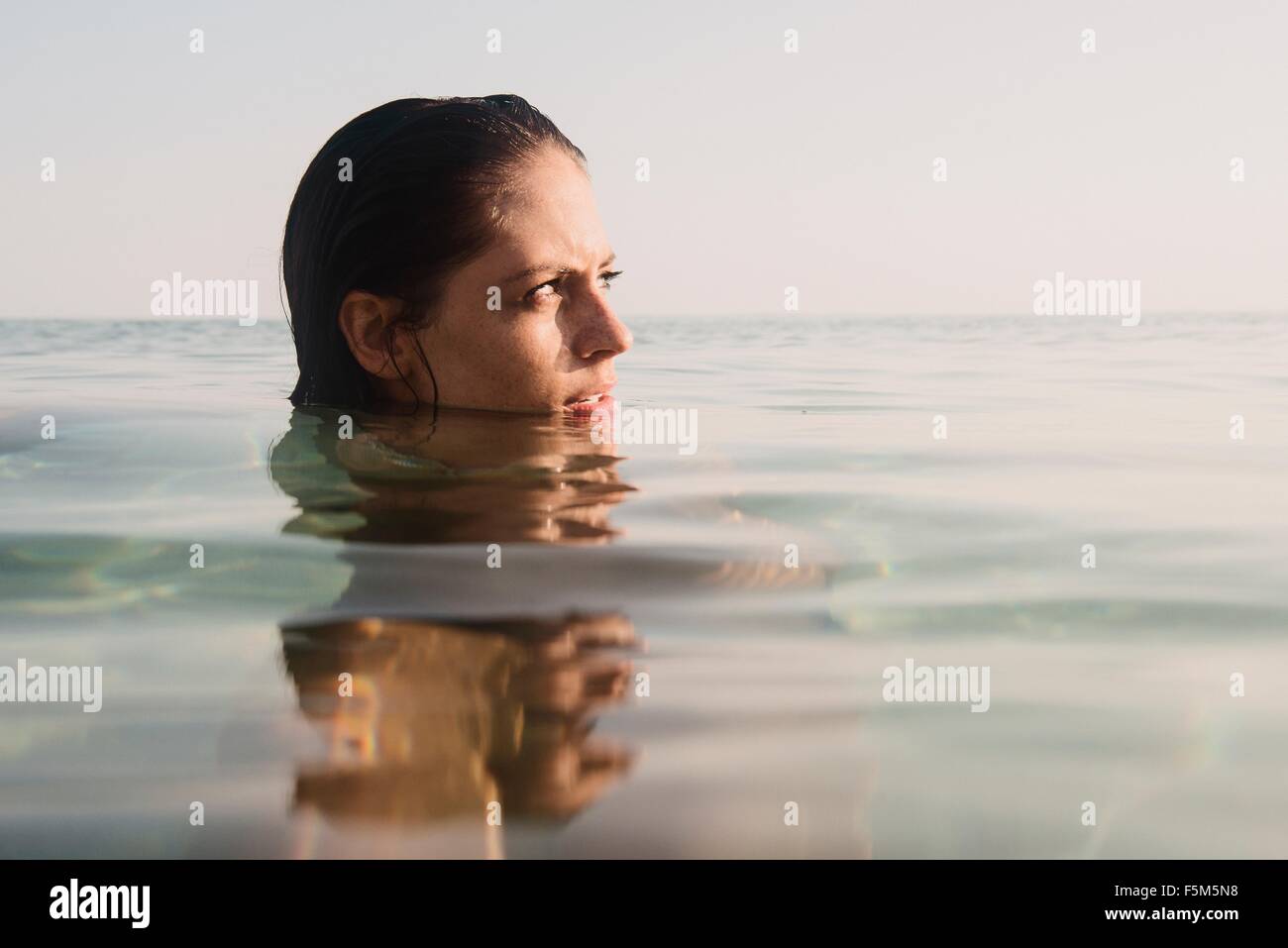 Head portrait of young woman in sea Stock Photo