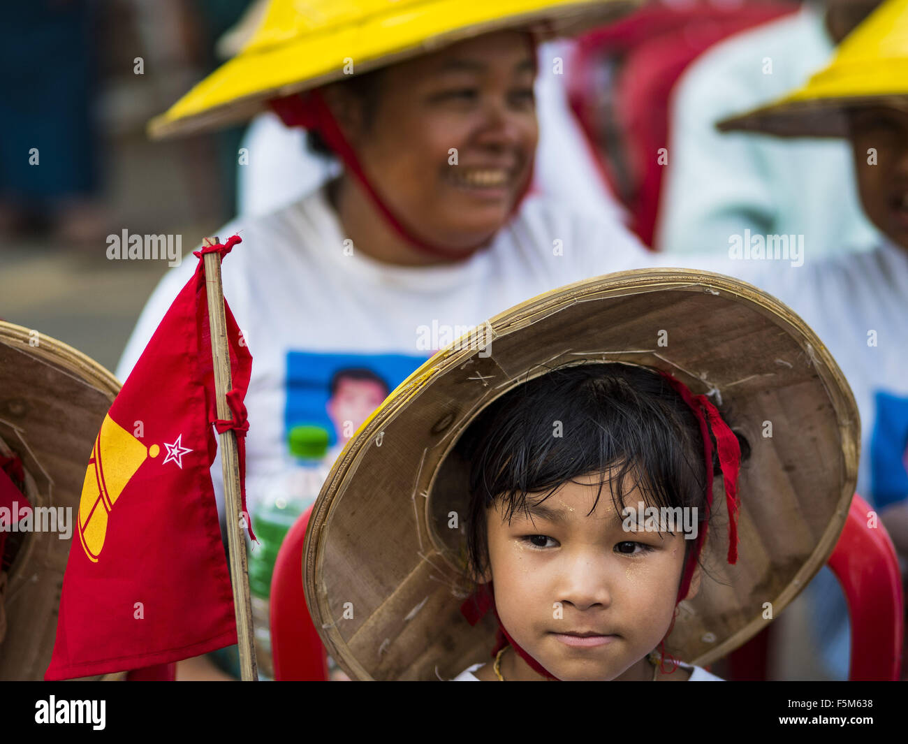 Yangon, Yangon Division, Myanmar. 6th Nov, 2015. People wait for the final NDF election rally of the 2015 election to start. The rally was held in central Yangon, next to the historic Sule Pagoda and across the street from Yangon city hall. The National Democratic Force (NDF) was formed by former members of the National League for Democracy (NLD) who chose to contest the 2010 general election in Myanmar because the NLD boycotted that election. There have been mass defections from the NFD this year because many of the people who joined the NFD in 2010 have gone back to the NLD, which is contes Stock Photo