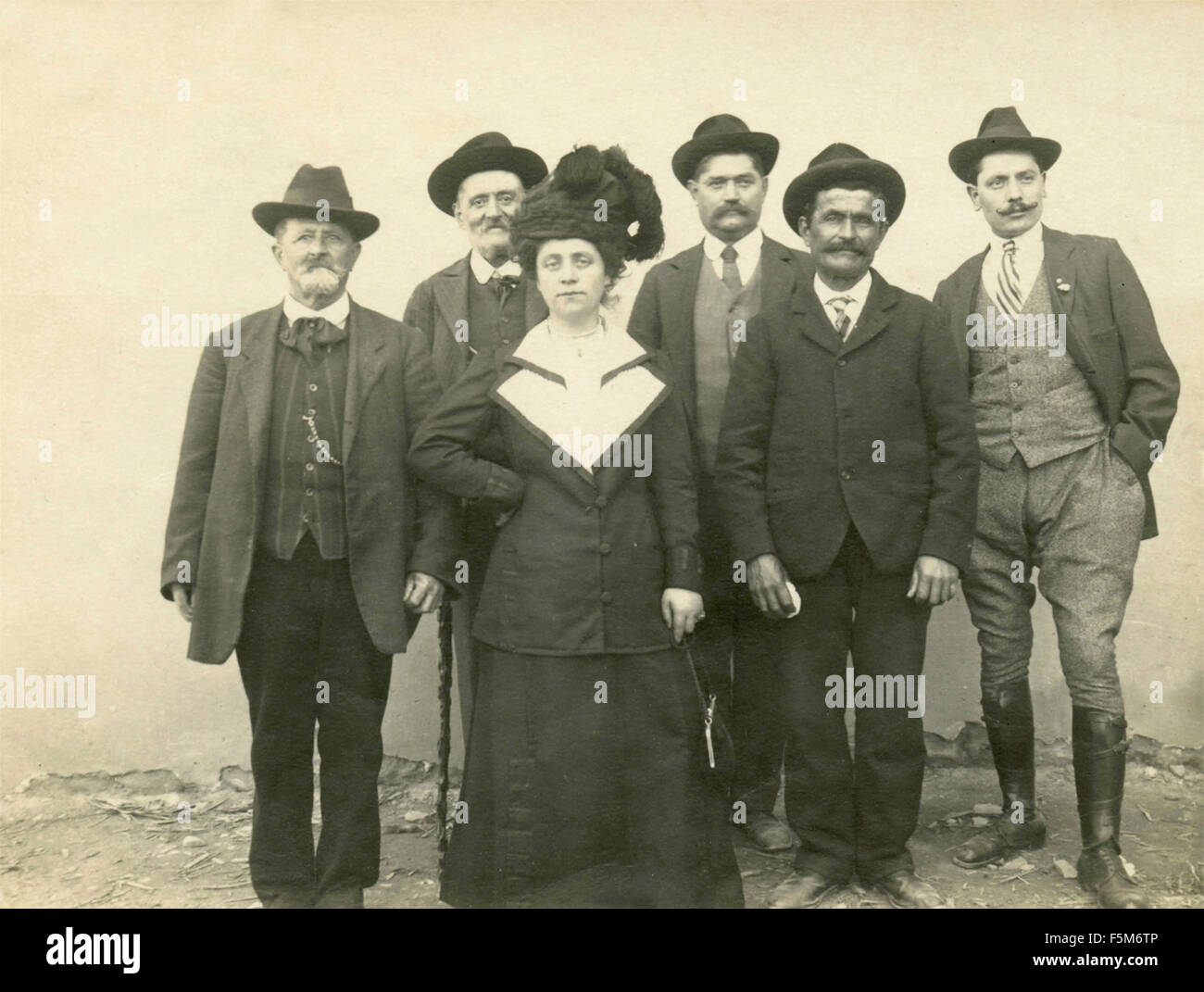 A group of men and a woman with hat, Italy Stock Photo