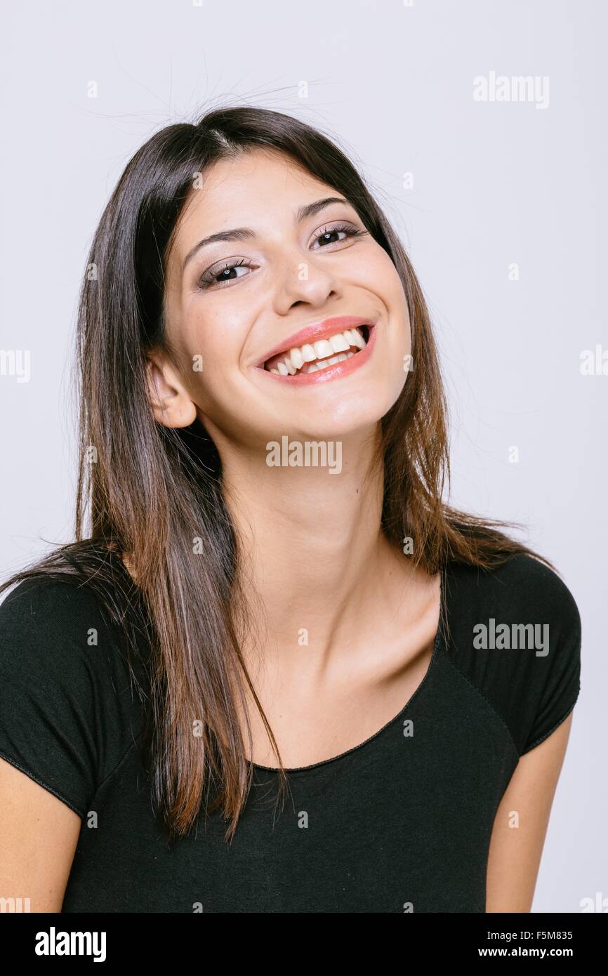 Head and shoulder portrait of young woman looking at camera smiling ...