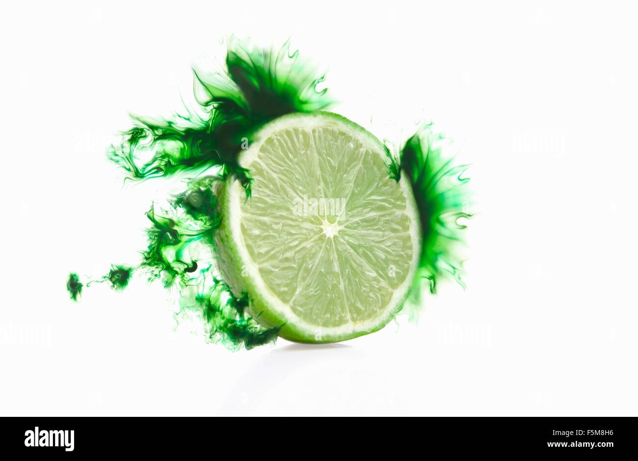 Half a lime with corresponding coloured digital burst effect Stock Photo