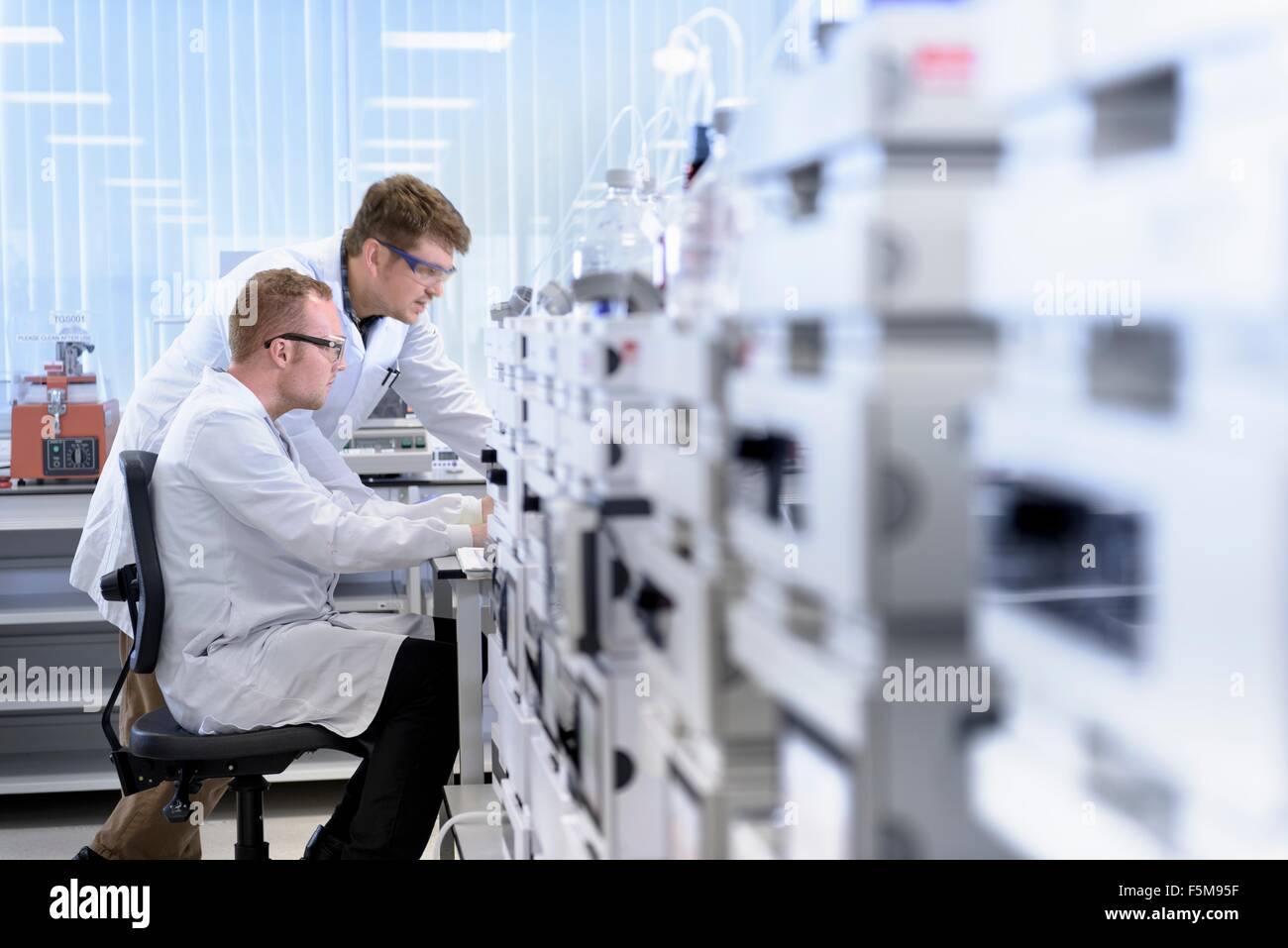 Scientists testing samples in laboratory Stock Photo