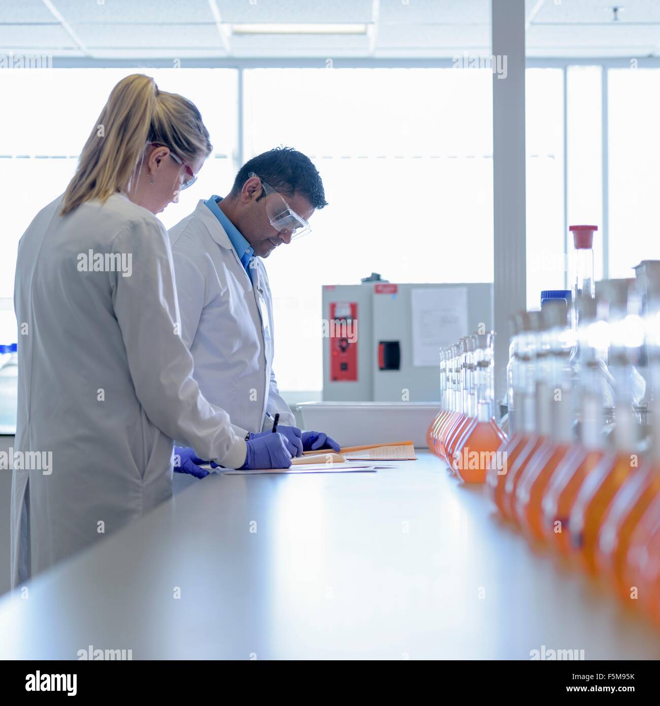 Laboratory chemists inspecting food colouring in laboratory Stock Photo