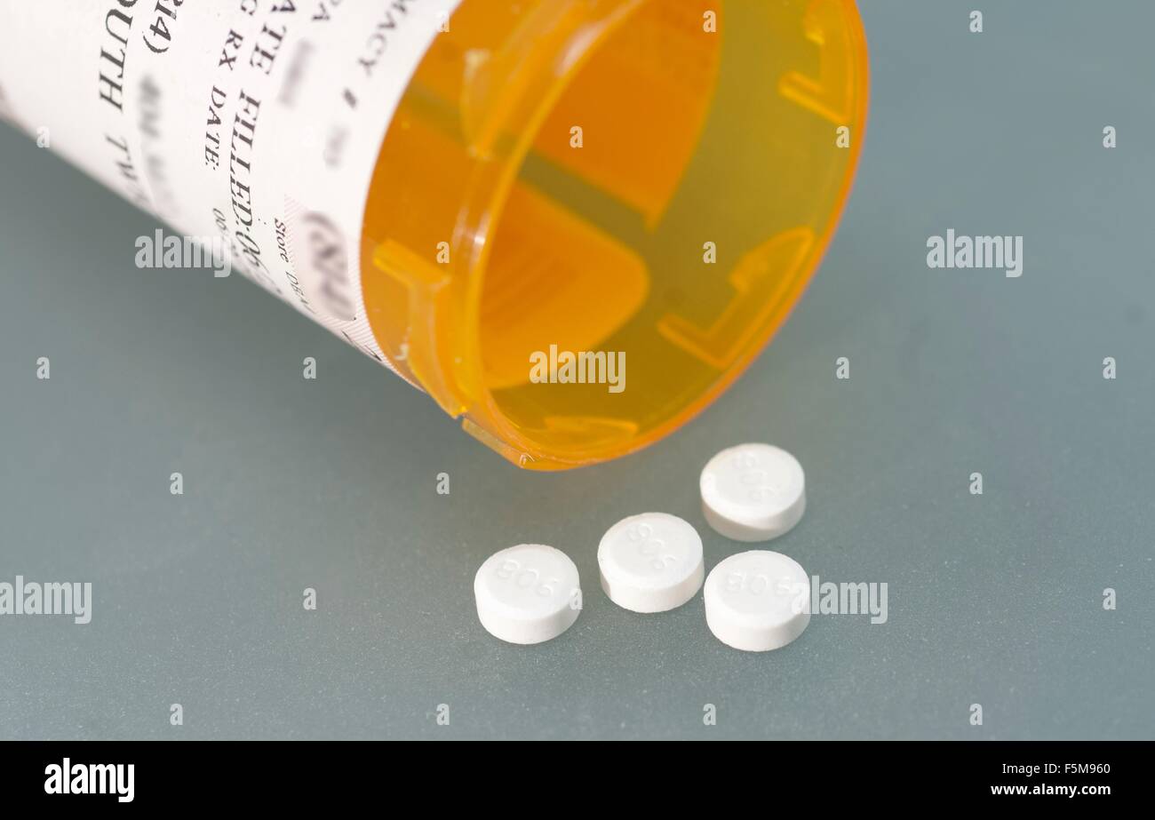 Ivermectin (a broad-spectrum antiparasitic agent) pills and pill bottle Stock Photo