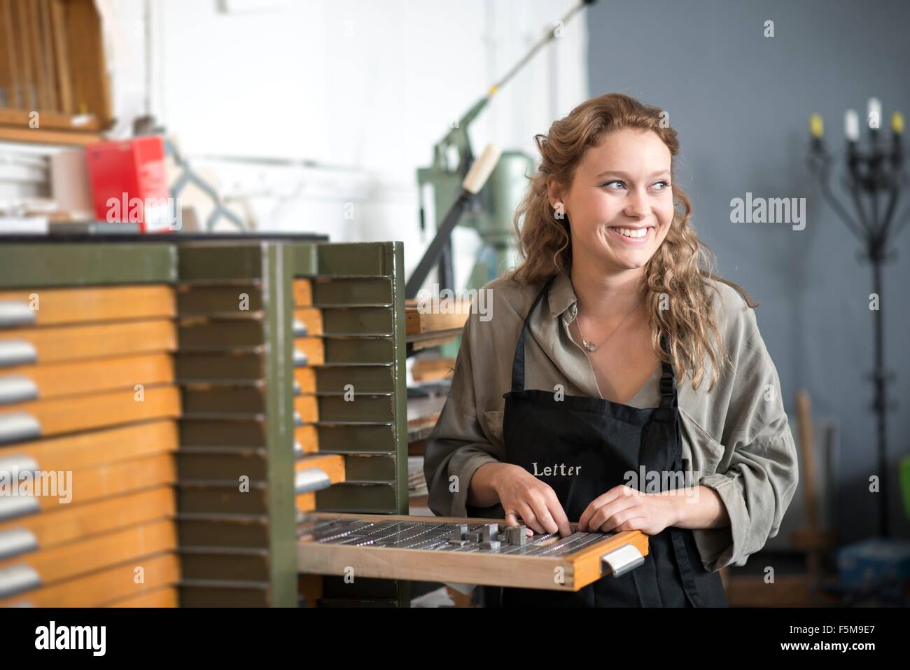 Woman with letterpress tray in print workshop Stock Photo