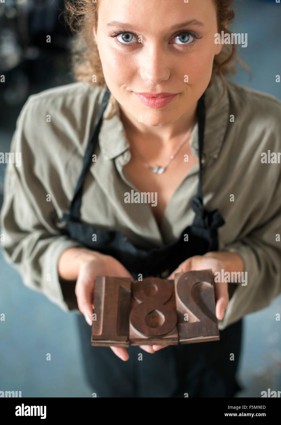 Woman holding traditional letterpress numerals workshop Stock Photo
