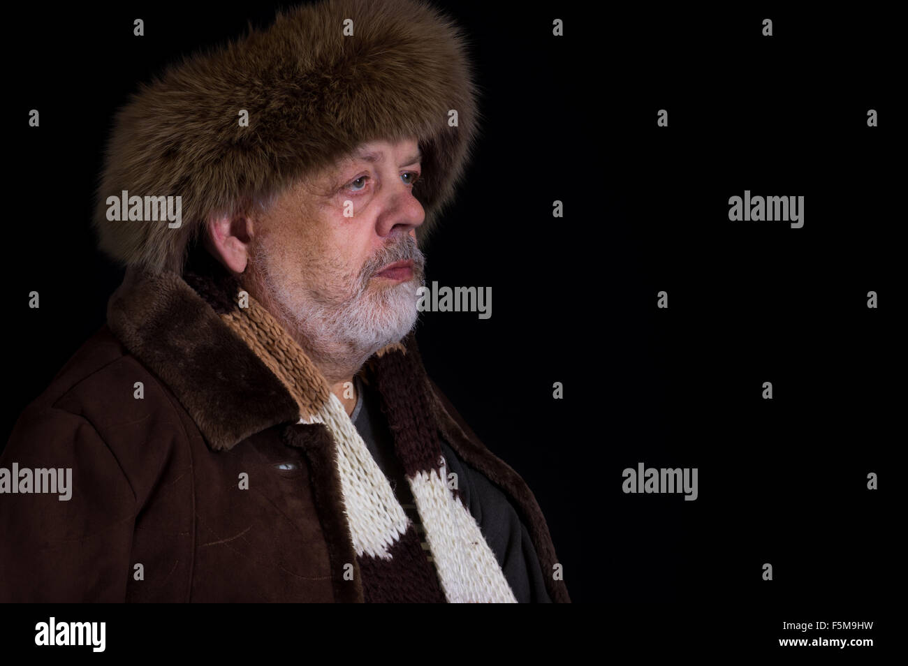 Portrait of tough senior man in winter clothes in studio Stock Photo