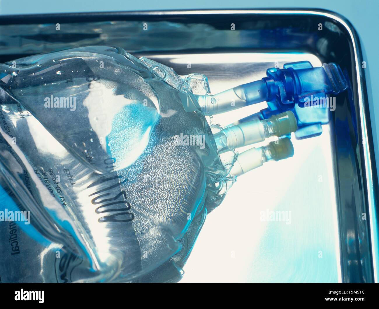 Close up of sealed intravenous drip bag on a surgical tray Stock Photo