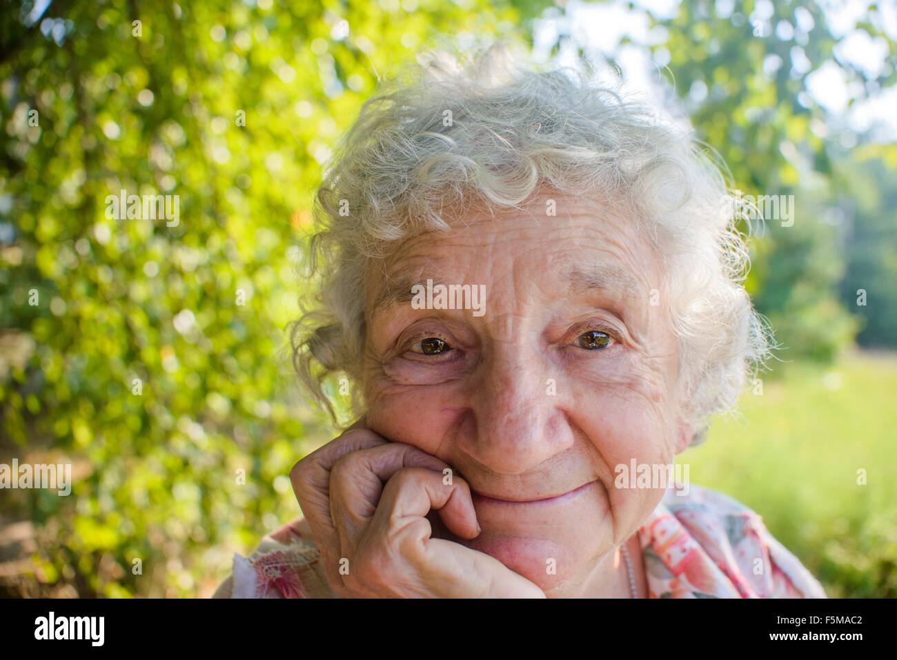Close up of smiling senior woman outdoors Stock Photo