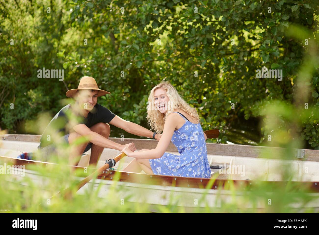 Portrait of young couple rowing river rowing boat Stock Photo