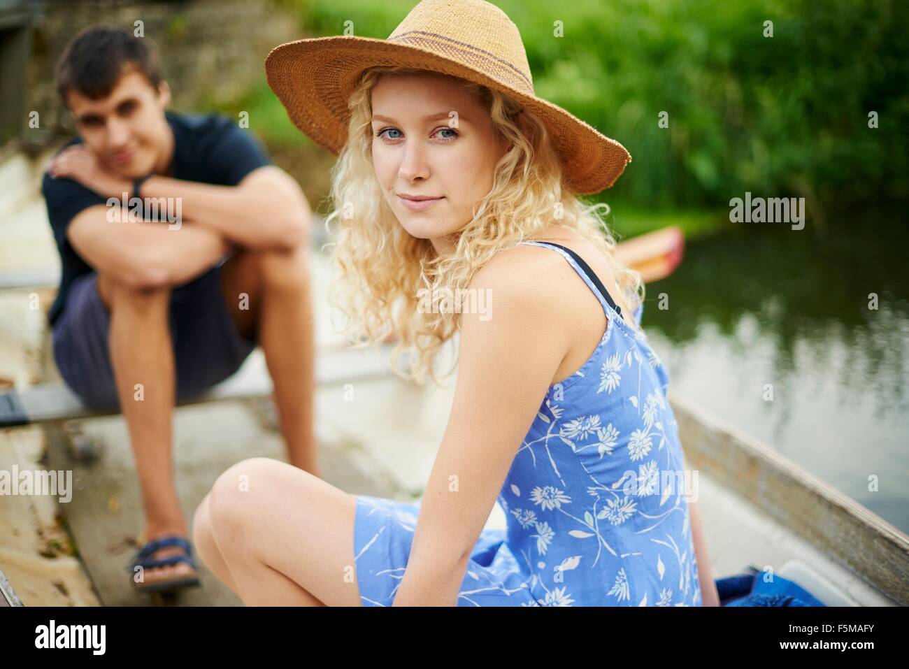 Portrait of young couple in rowing boat on river Stock Photo