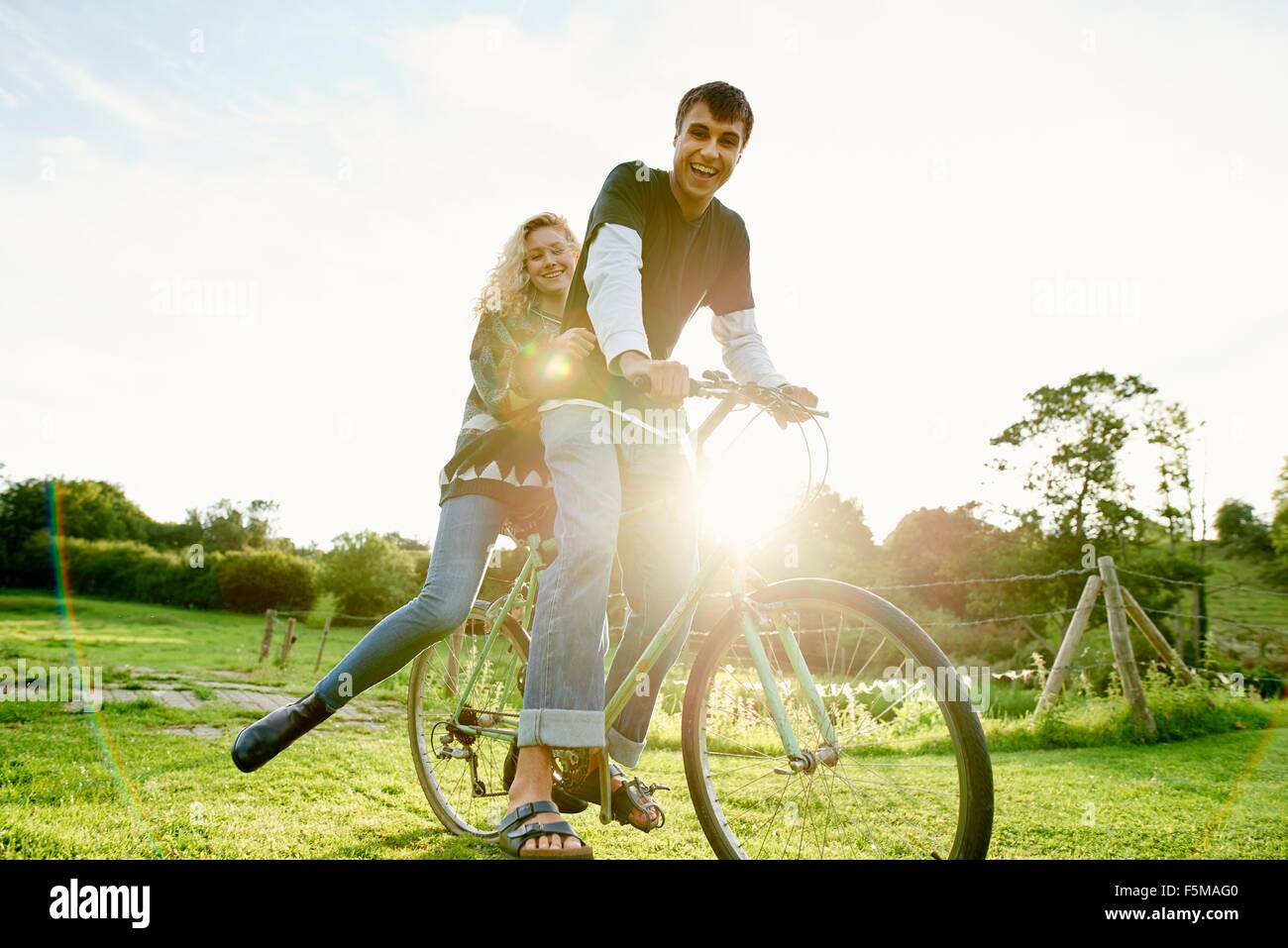 Portrait of young couple on bicycle Stock Photo