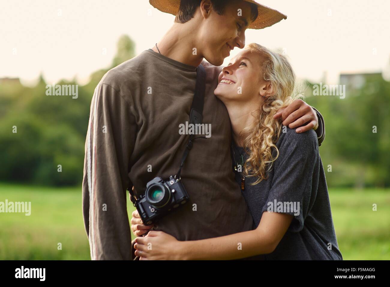 Romantic young couple in rural field Stock Photo