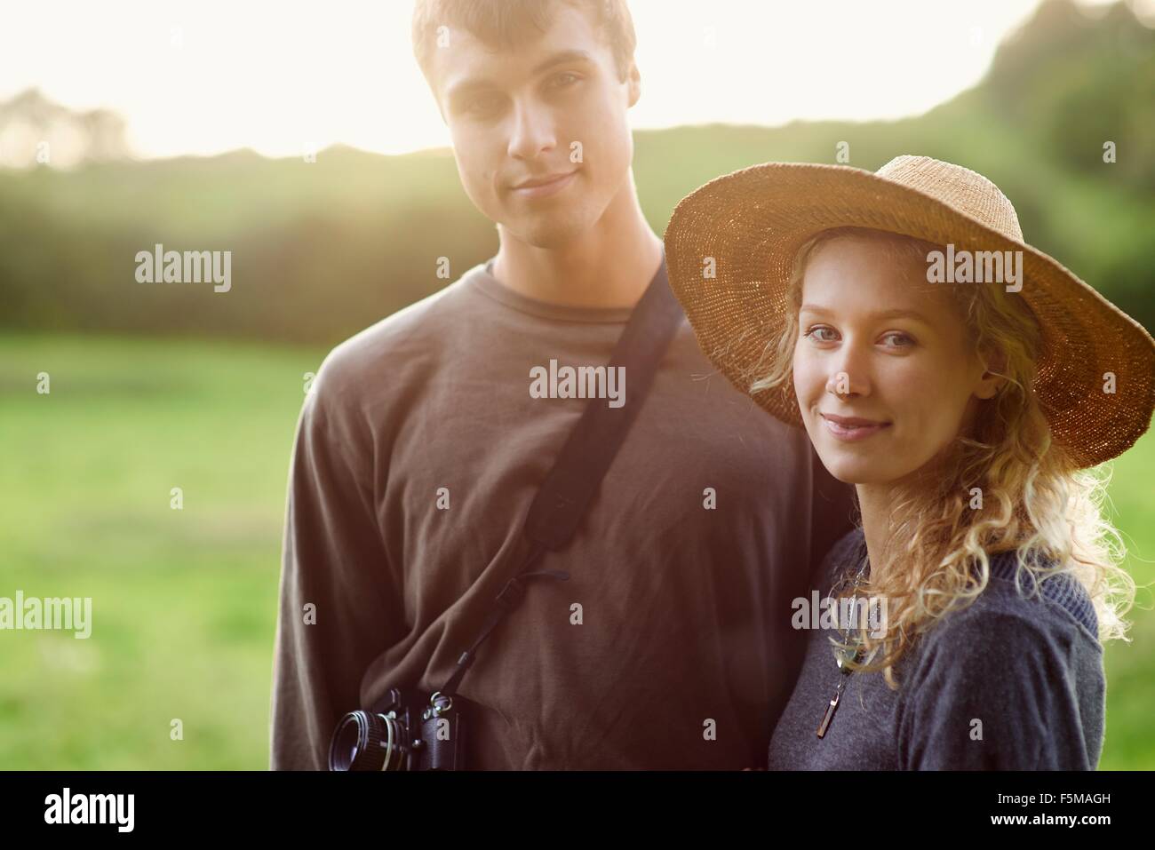 Portrait of romantic young couple in rural field Stock Photo