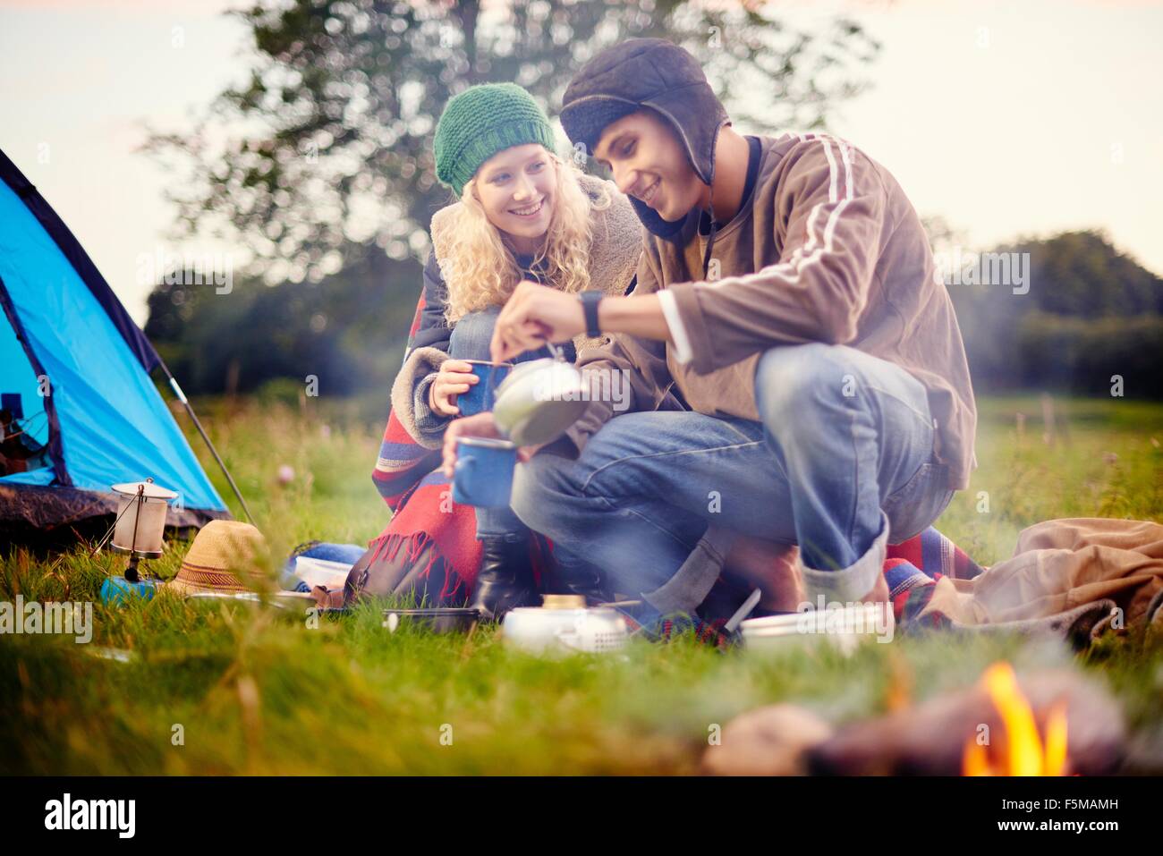 Young camping couple pouring tea Stock Photo