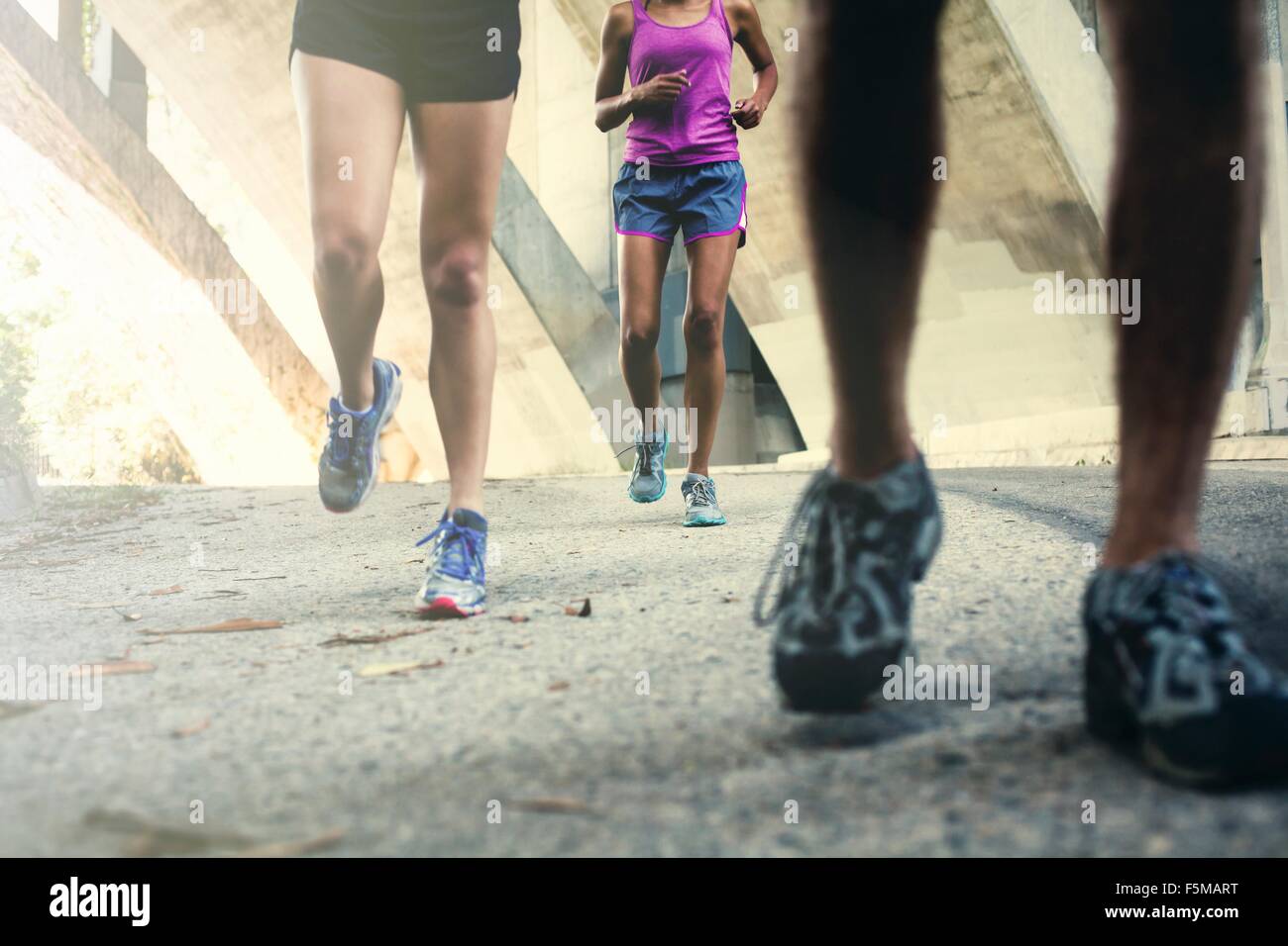 Joggers running on bridge Stock Photo