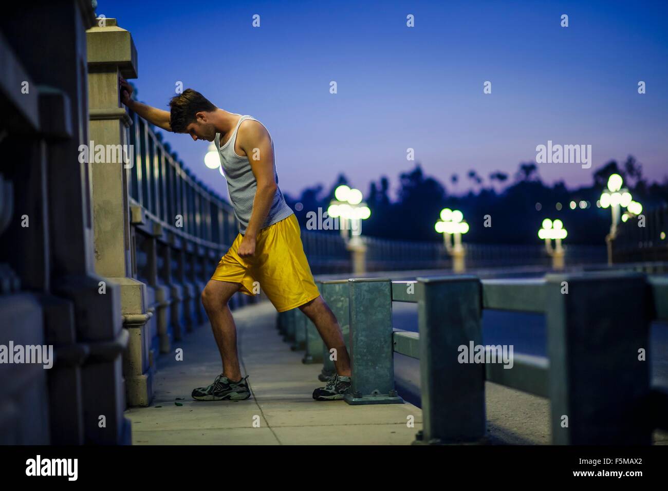 Young man stretching on bridge hi-res stock photography and images - Alamy
