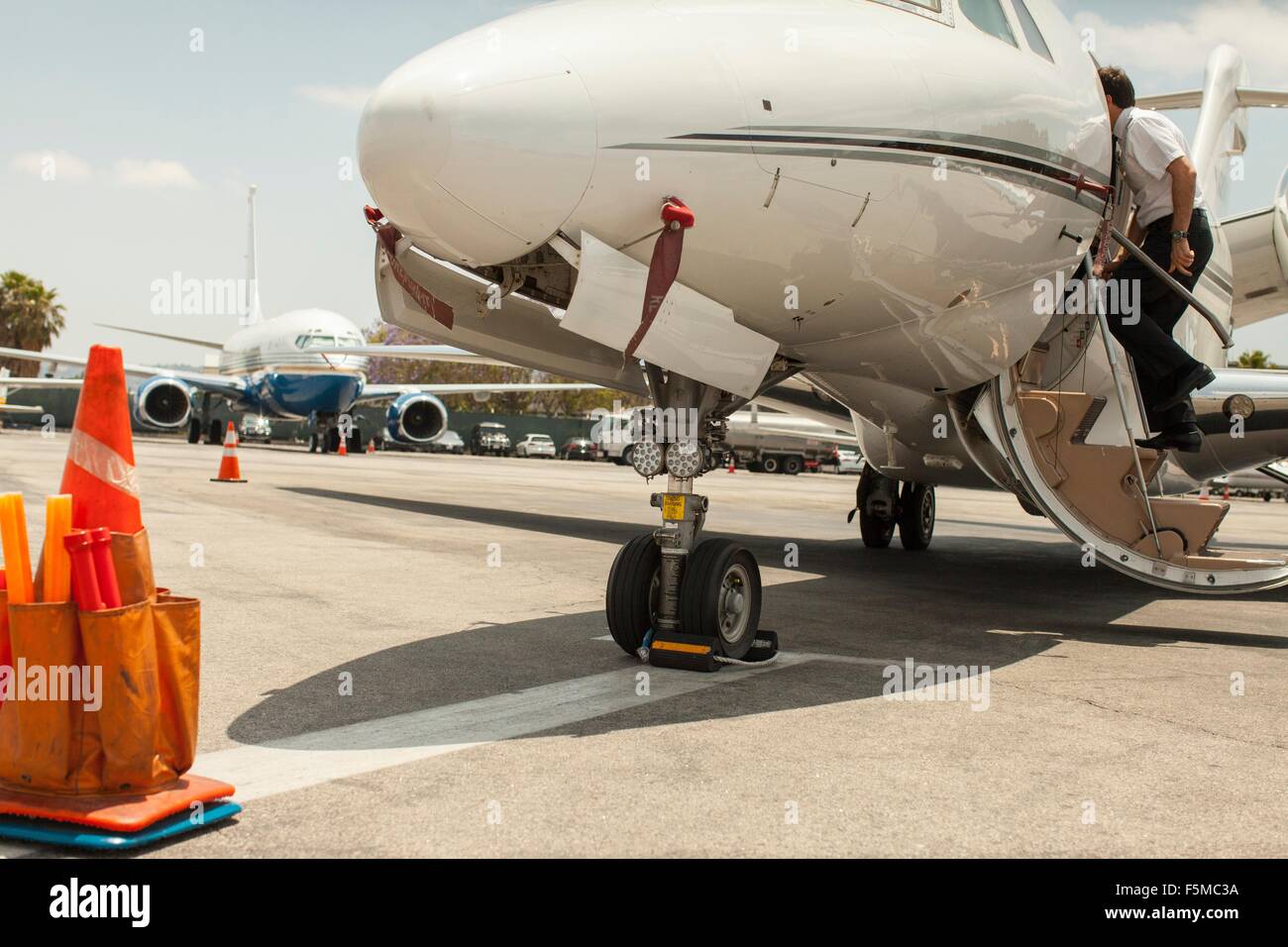 Male private jet pilots boarding plane at airport Stock Photo Alamy