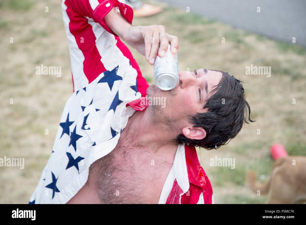 Young man kissing beer can celebrating Independence Day, USA Stock Photo