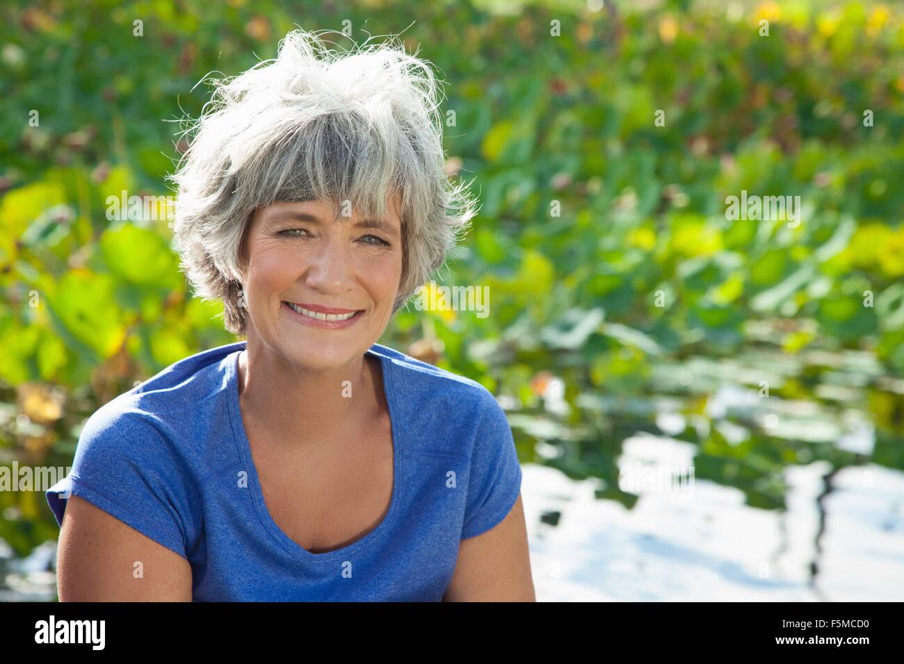 Portrait of mature woman, smiling, outdoors Stock Photo