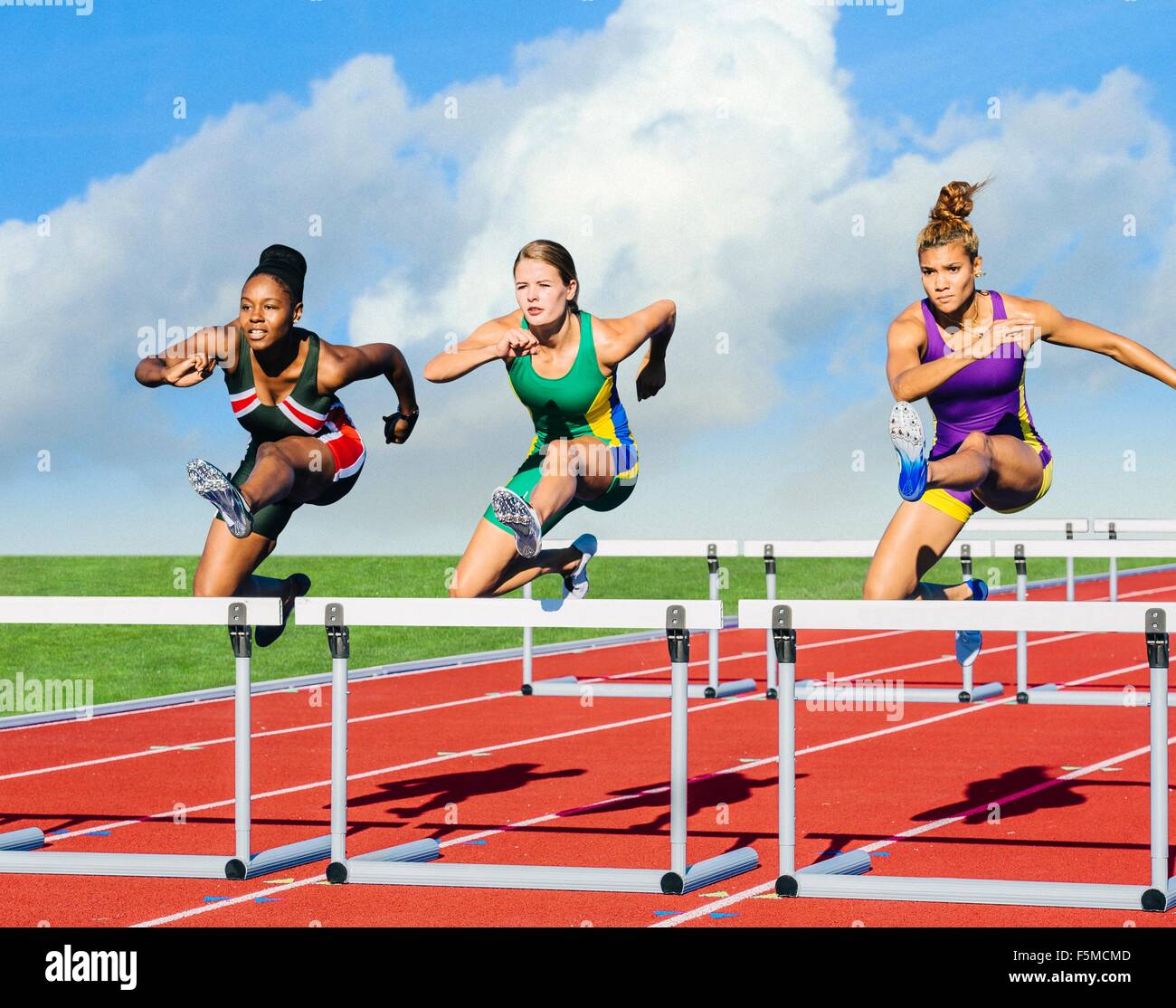 Runners Jumping Over Hurdle On Track Stock Photo Alamy Runners Jumping Over Hurdle On Track Stock Photo Alamy